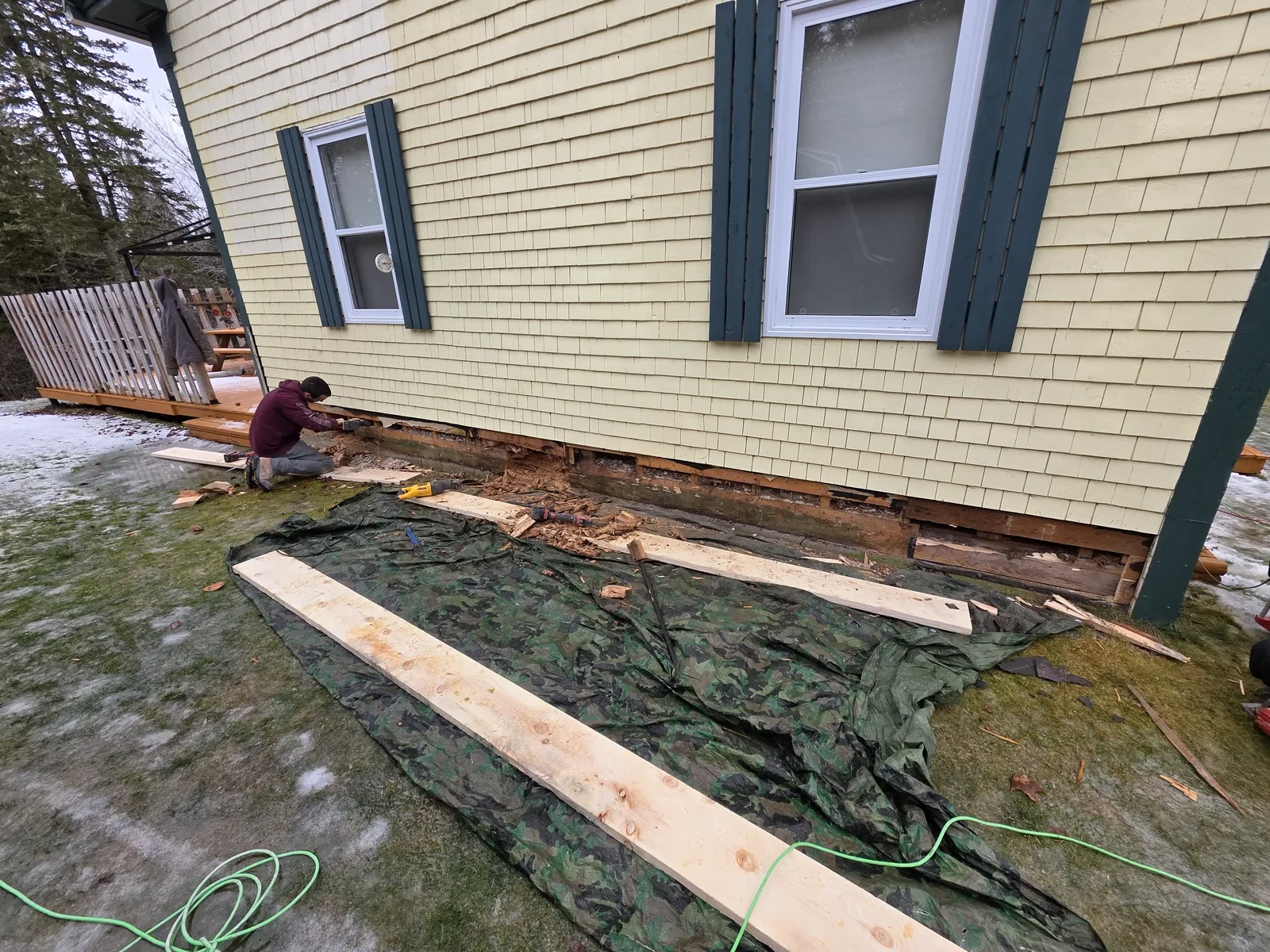 Water-damaged bottom trim and sheathing before repair